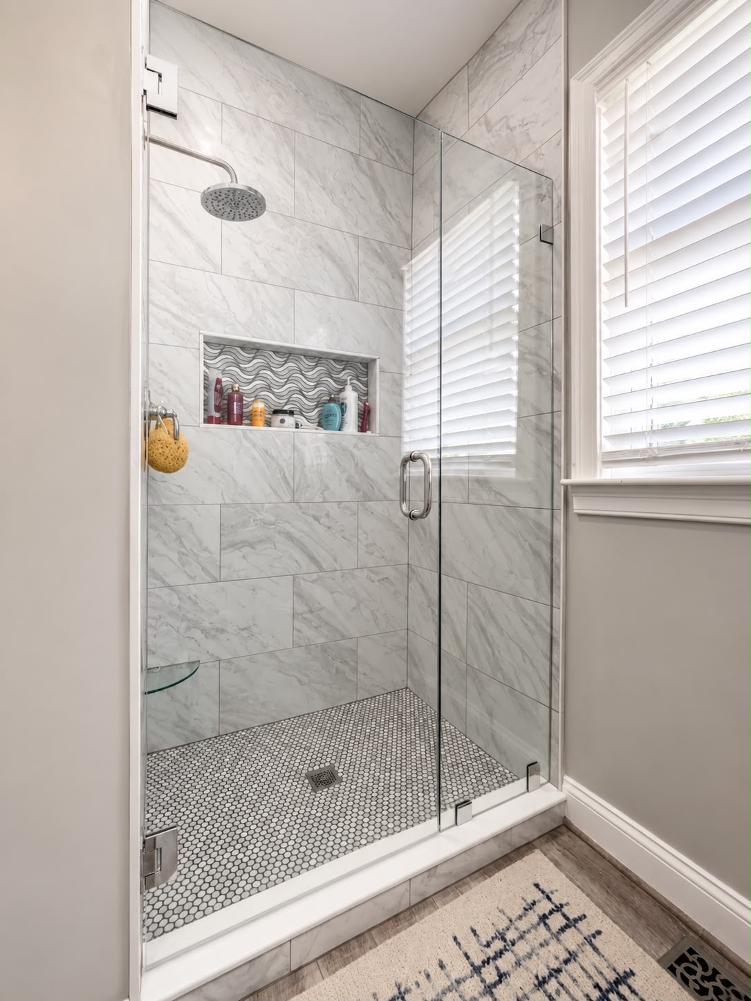 Marble shower by Horus Glassworks — Polished chrome hardware
