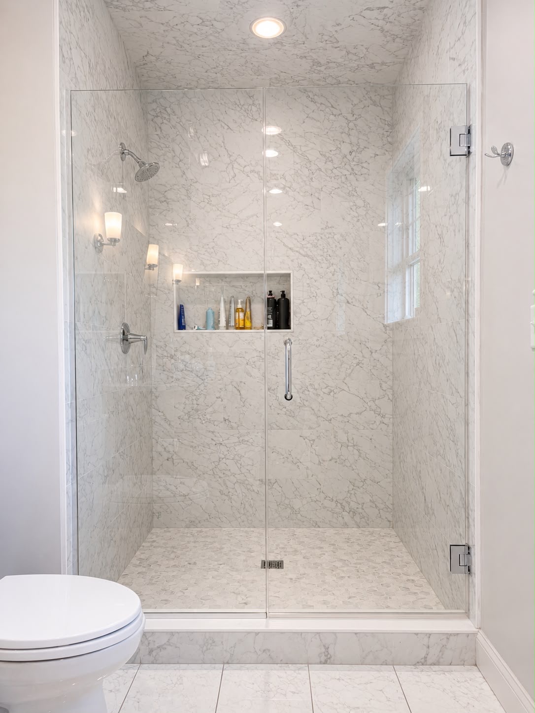 Veined marble shower by Horus Glassworks — Clear glass & chrome
